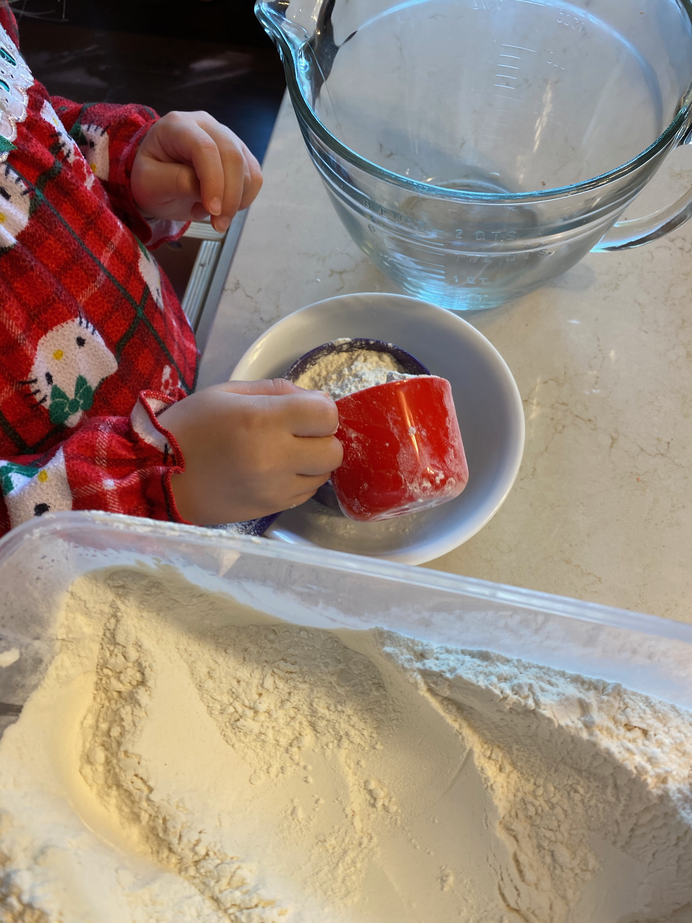 Gwen scooping into the measuring cup