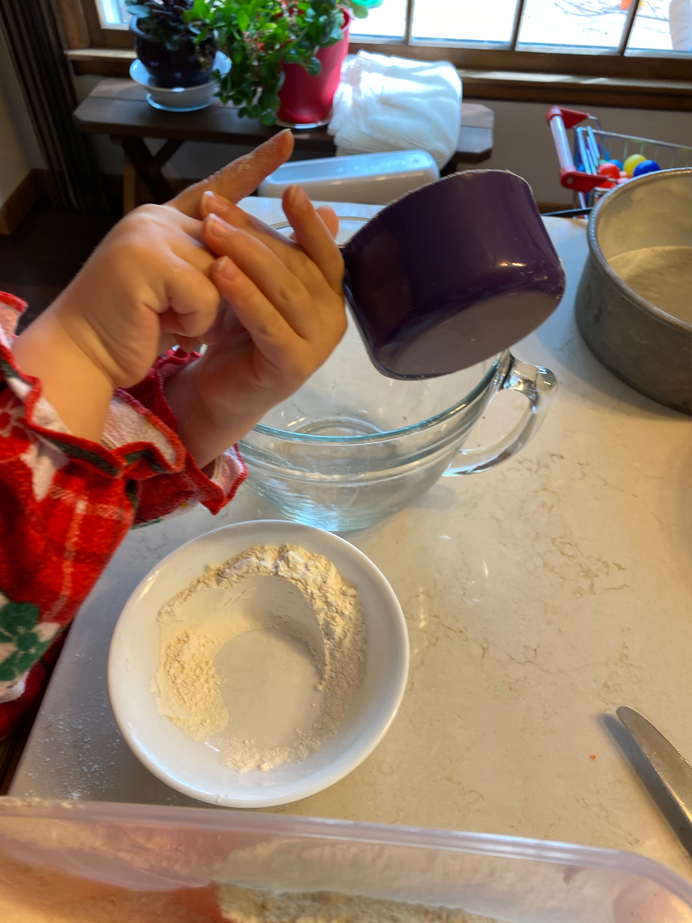 Gwen pouring into the mixing bowl
