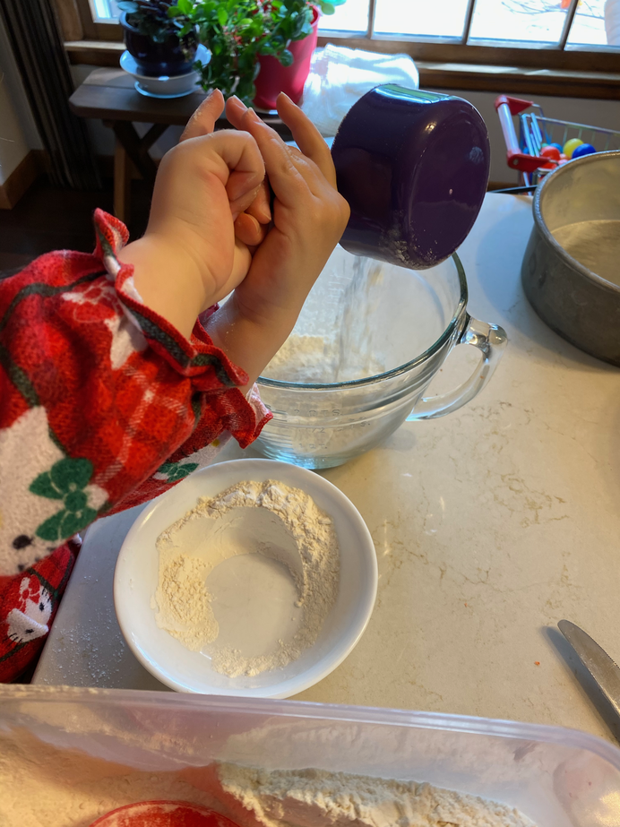 Gwen pouring into the mixing bowl