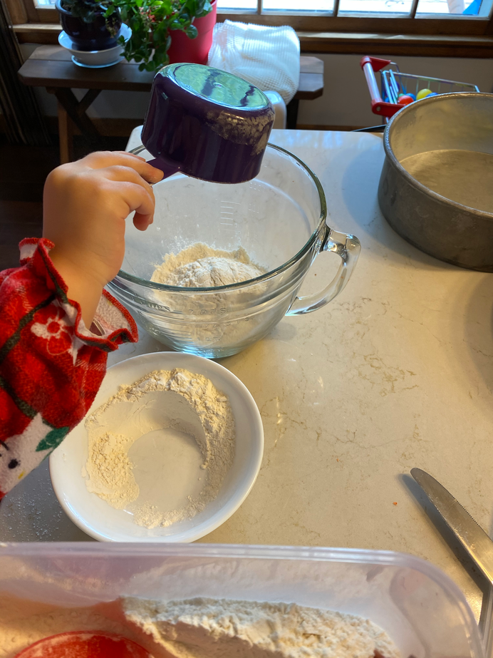 Gwen pouring into the mixing bowl